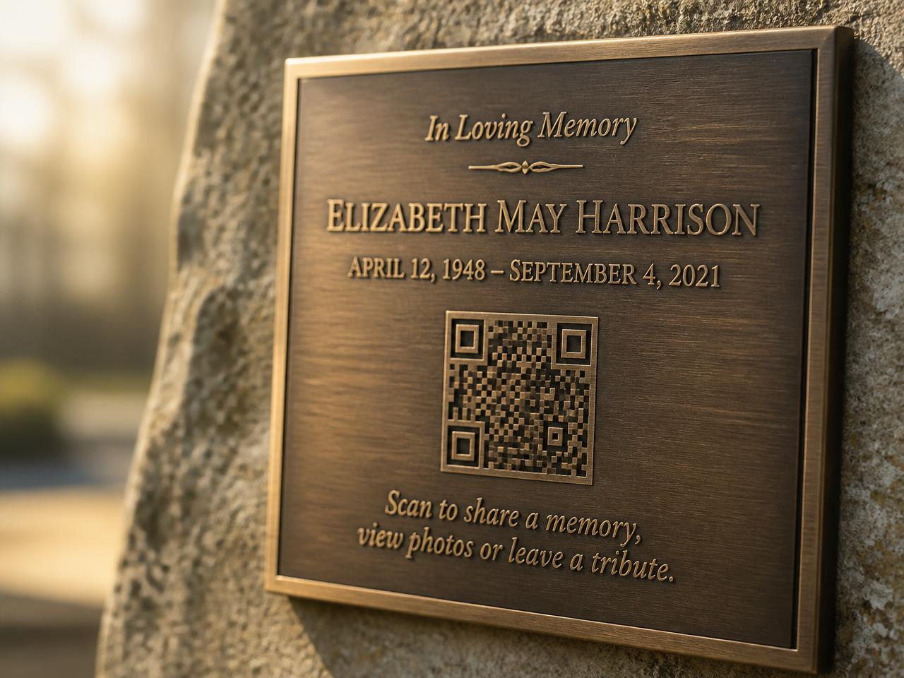 A bronze memorial plaque engraved with a memorial QR code